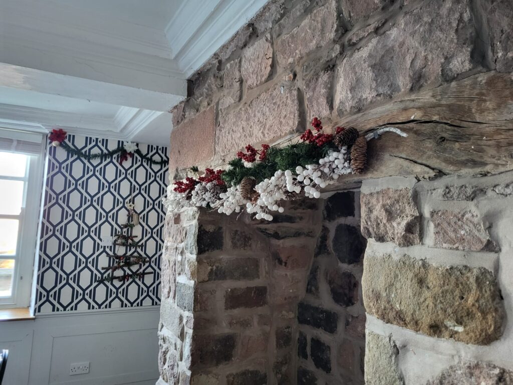 Festive garland on the stone fireplace at Toft Estate